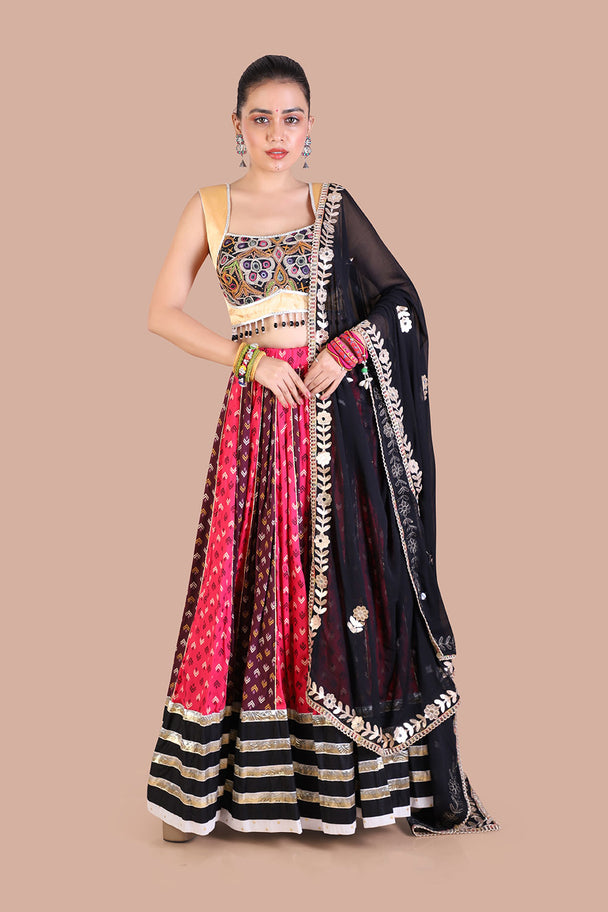 traditional print lehenga with gold blouse contrasting black dupatta for navratri festive