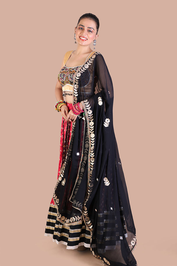 traditional print lehenga with gold blouse contrasting black dupatta for navratri festive