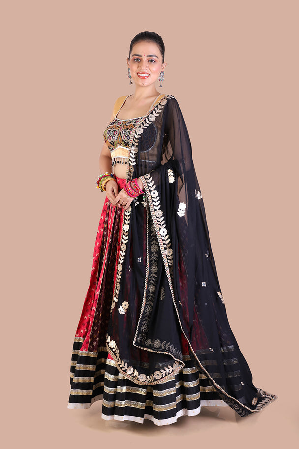 traditional print lehenga with gold blouse contrasting black dupatta for navratri festive