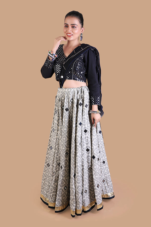 black embroidered blouse with silver mirror work lehenga