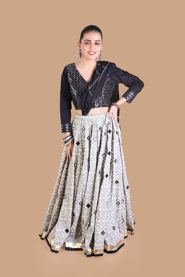 black embroidered blouse with silver mirror work lehenga