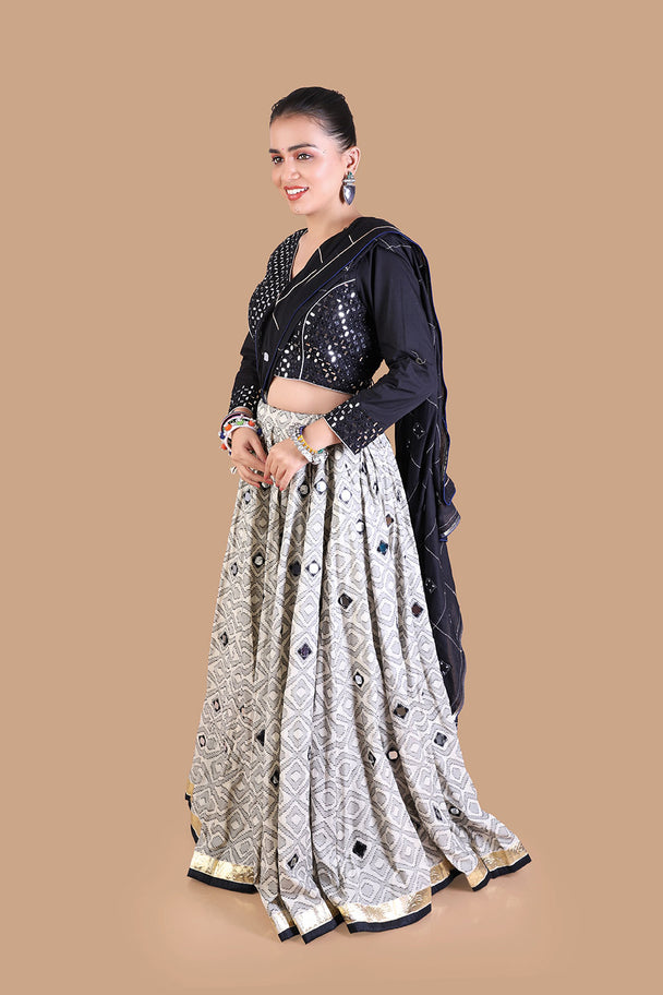 black embroidered blouse with silver mirror work lehenga