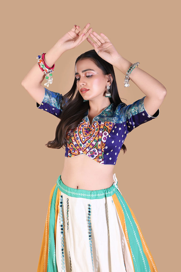 white flared lehenga with multicolor striped panels & blue embroidered blouse